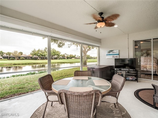 sunroom featuring ceiling fan and a jacuzzi