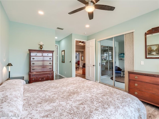 bedroom featuring access to exterior, a closet, light hardwood / wood-style flooring, and ceiling fan