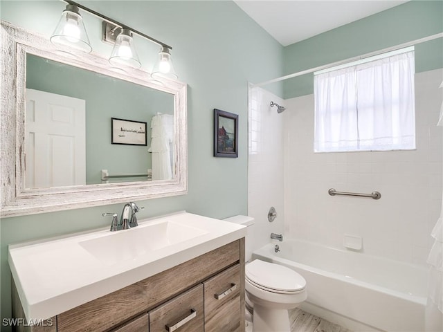 full bathroom with vanity, toilet, and tiled shower / bath