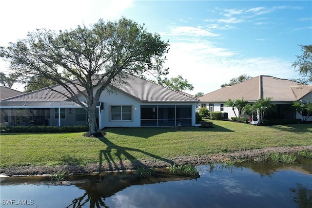 back of property featuring a yard and a water view