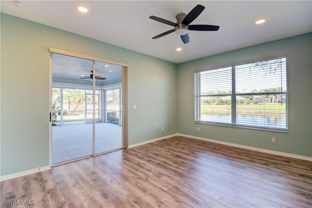 spare room featuring light hardwood / wood-style flooring and ceiling fan