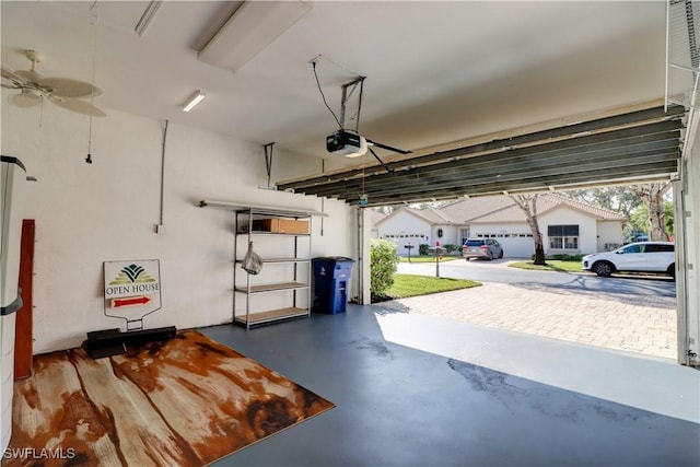 garage with ceiling fan and a garage door opener