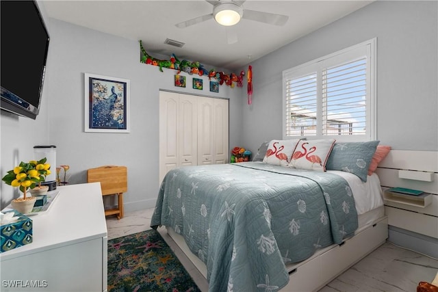 bedroom with ceiling fan and a closet