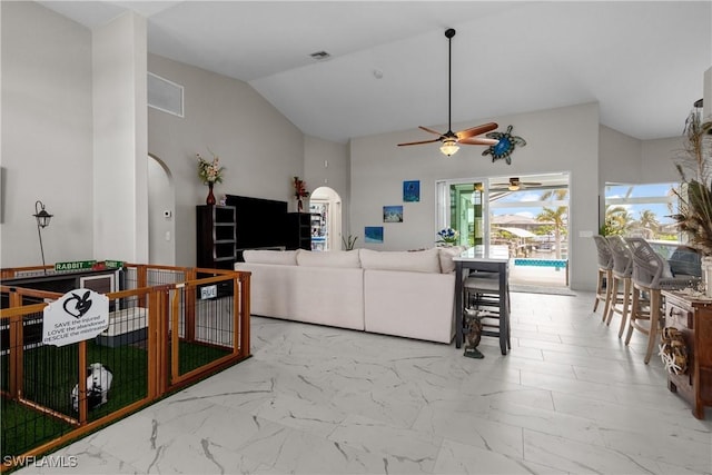 living room featuring ceiling fan and vaulted ceiling