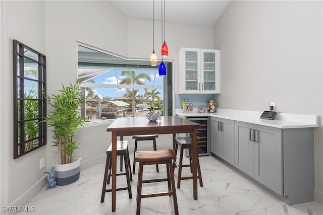 dining area with beverage cooler and indoor bar