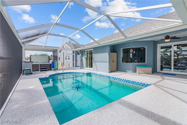 view of swimming pool featuring ceiling fan, a lanai, and a patio