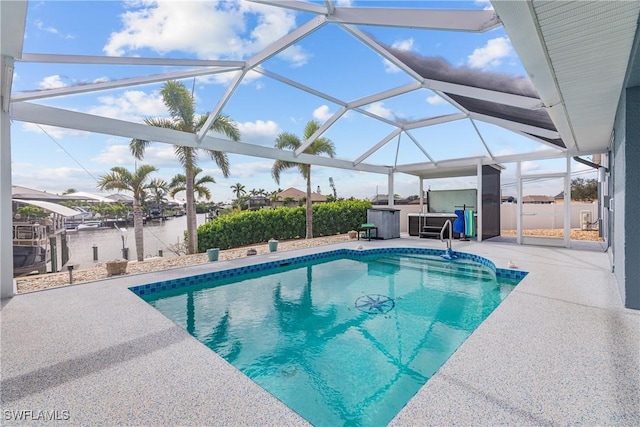 view of pool with a water view, a patio, and a lanai