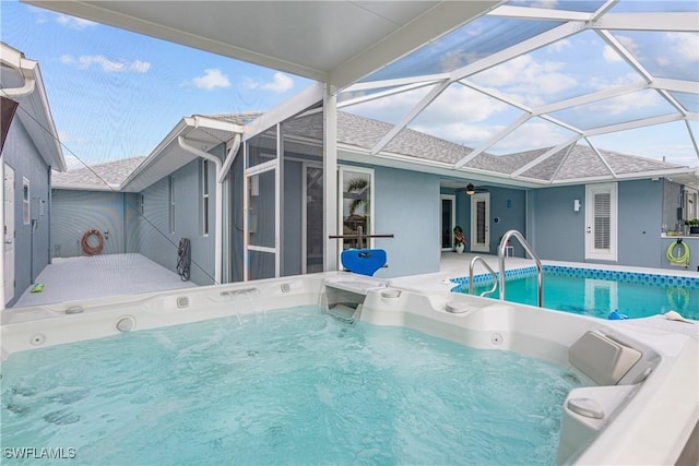 view of pool with a patio area, ceiling fan, and glass enclosure