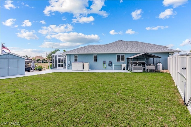 back of property with a patio, a jacuzzi, glass enclosure, and a lawn