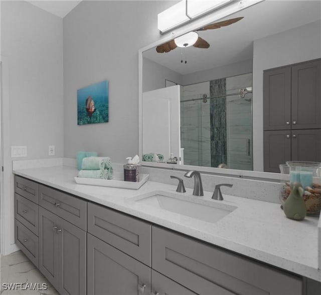 bathroom with ceiling fan, vanity, and an enclosed shower