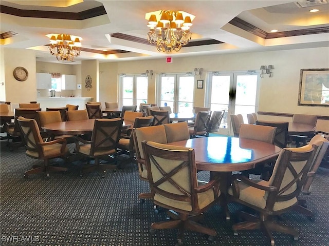 dining room featuring a healthy amount of sunlight, a raised ceiling, crown molding, and an inviting chandelier