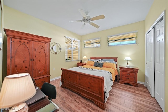 bedroom featuring ceiling fan, light hardwood / wood-style floors, and a closet