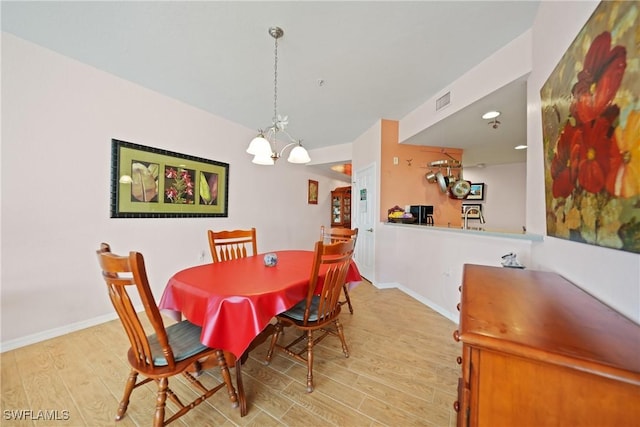 dining room featuring a chandelier and light hardwood / wood-style floors