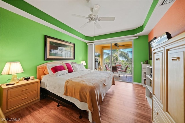 bedroom with access to outside, ceiling fan, and wood-type flooring