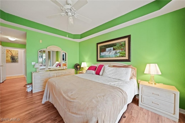 bedroom with ceiling fan and light hardwood / wood-style flooring