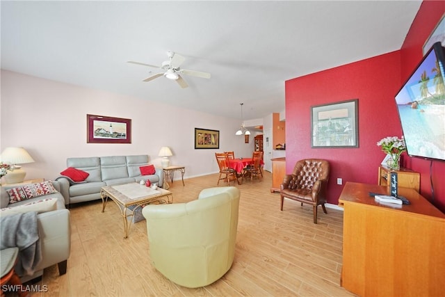 living room featuring light hardwood / wood-style floors and ceiling fan