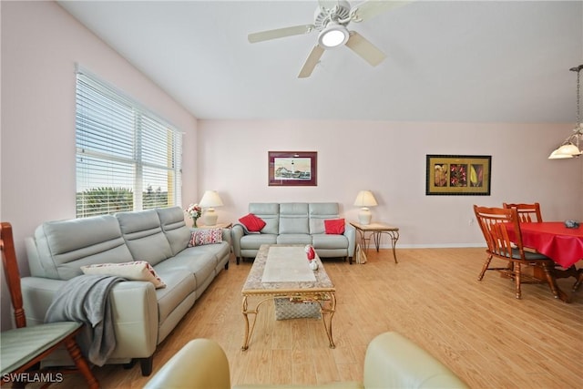 living room featuring light wood-type flooring and ceiling fan