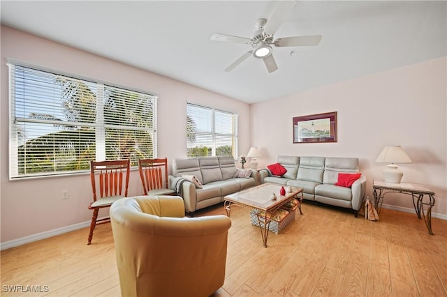 living room with ceiling fan and light hardwood / wood-style flooring