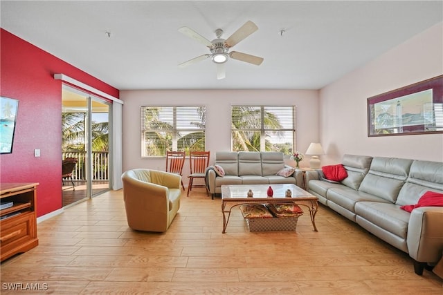 living room featuring ceiling fan, a healthy amount of sunlight, and light wood-type flooring