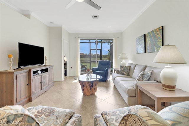 tiled living room with ceiling fan and crown molding