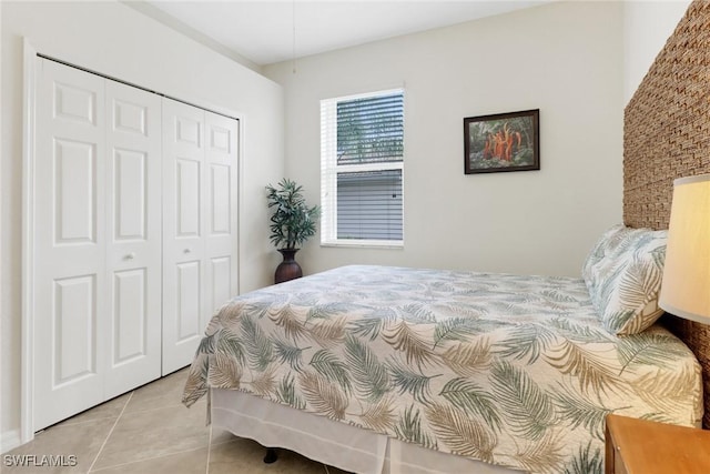 bedroom with a closet and light tile patterned flooring