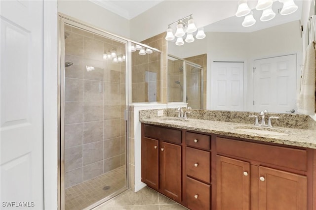 bathroom featuring tile patterned flooring, vanity, an enclosed shower, and crown molding