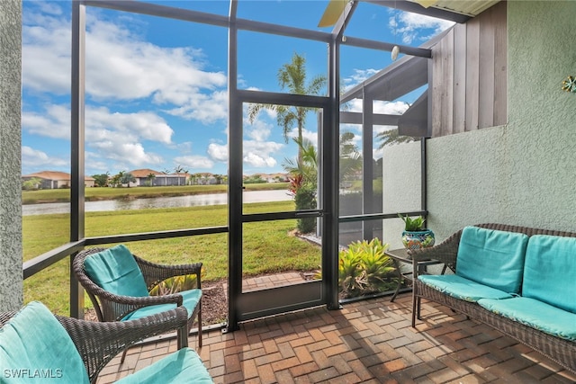 sunroom / solarium featuring a water view