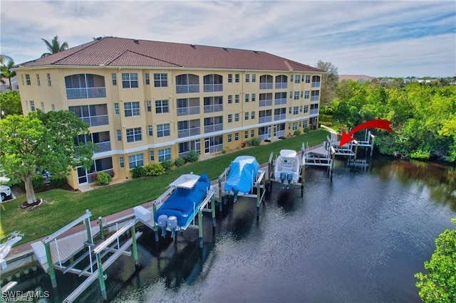 view of dock featuring a yard and a water view