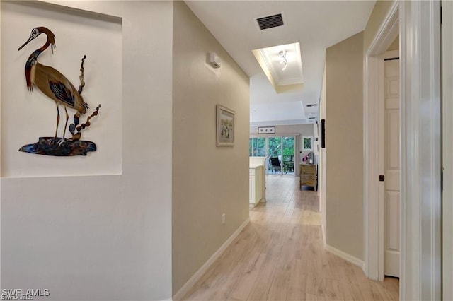 corridor featuring light hardwood / wood-style floors and ornamental molding