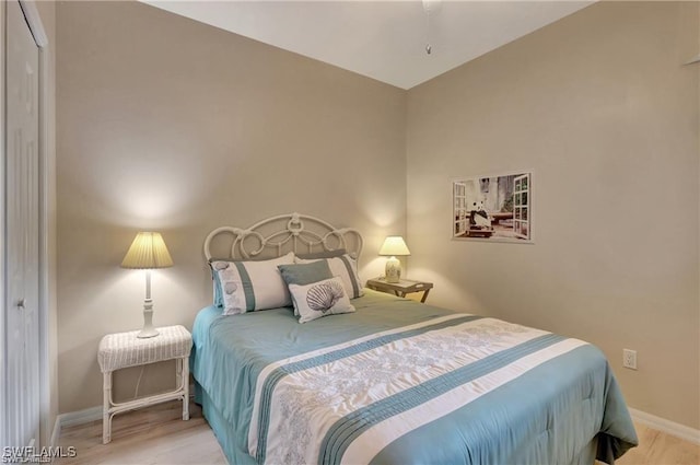 bedroom featuring light wood-type flooring and a closet