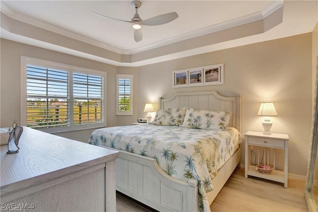 bedroom featuring light wood-type flooring, ceiling fan, and ornamental molding