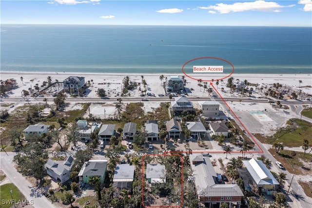 aerial view with a water view and a view of the beach