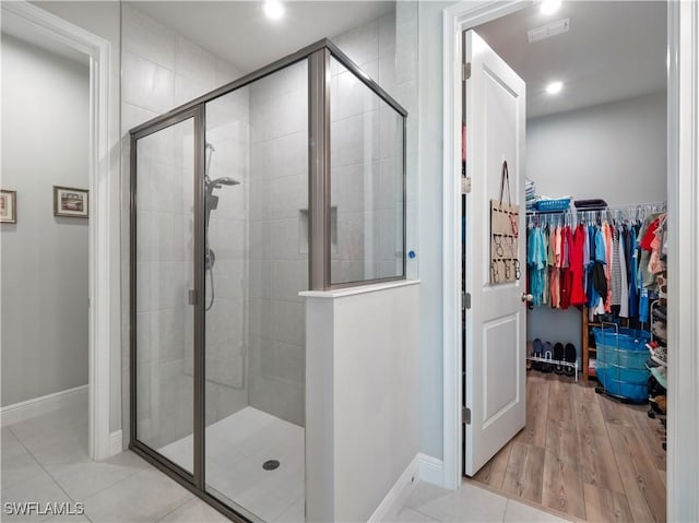 bathroom with tile patterned floors and an enclosed shower