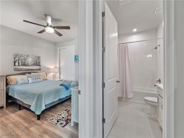 tiled bedroom with a closet and ceiling fan