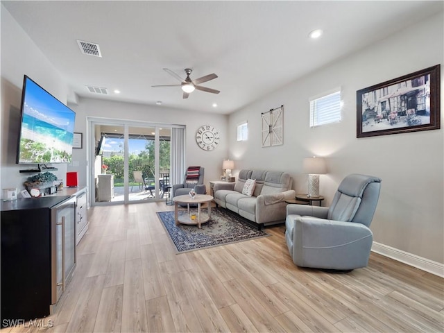 living room featuring light wood-type flooring and ceiling fan