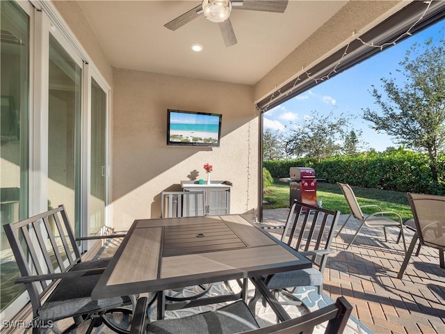 view of patio / terrace with area for grilling and ceiling fan