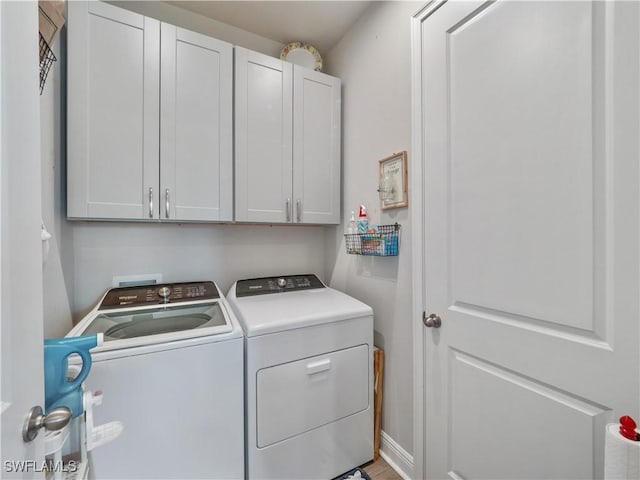 laundry area featuring cabinets and washing machine and clothes dryer