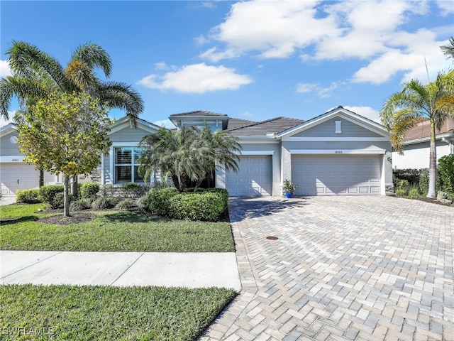 view of front of property with a front lawn and a garage