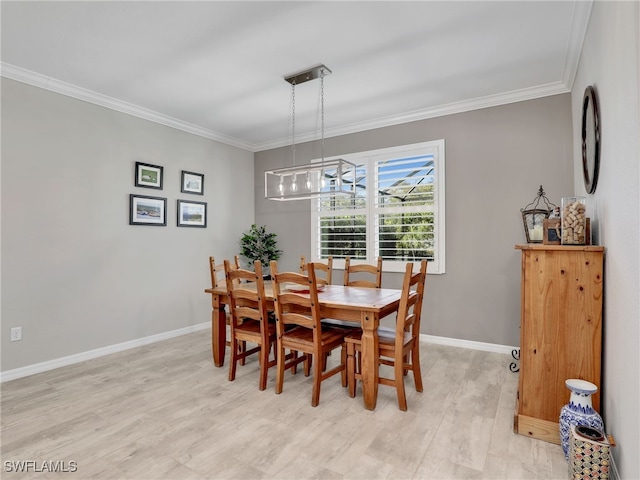 dining area featuring light wood-type flooring and ornamental molding