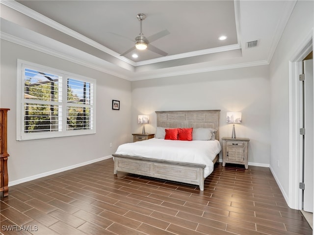 bedroom featuring ceiling fan, crown molding, and a tray ceiling