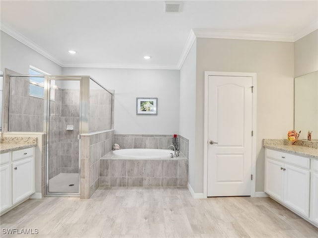 bathroom with vanity, crown molding, and separate shower and tub