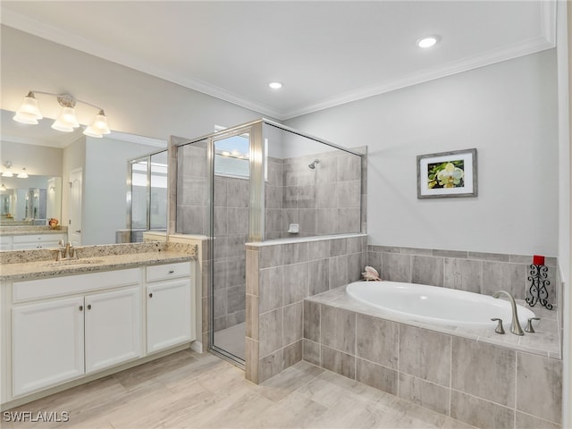 bathroom featuring vanity, crown molding, and separate shower and tub