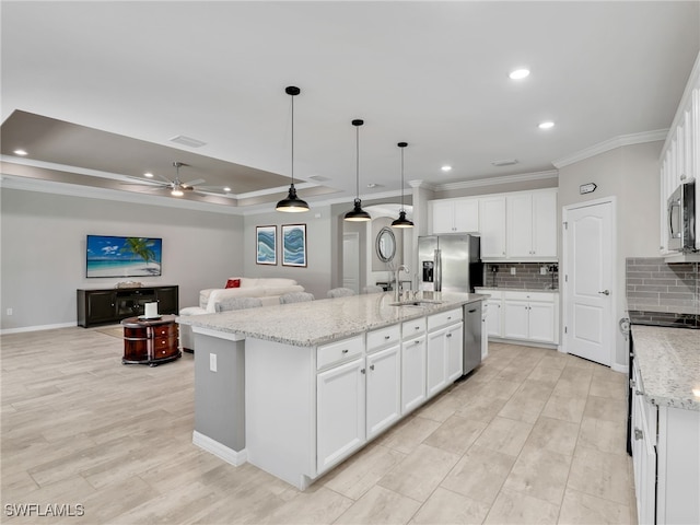 kitchen featuring stainless steel appliances, a kitchen island with sink, white cabinets, and sink