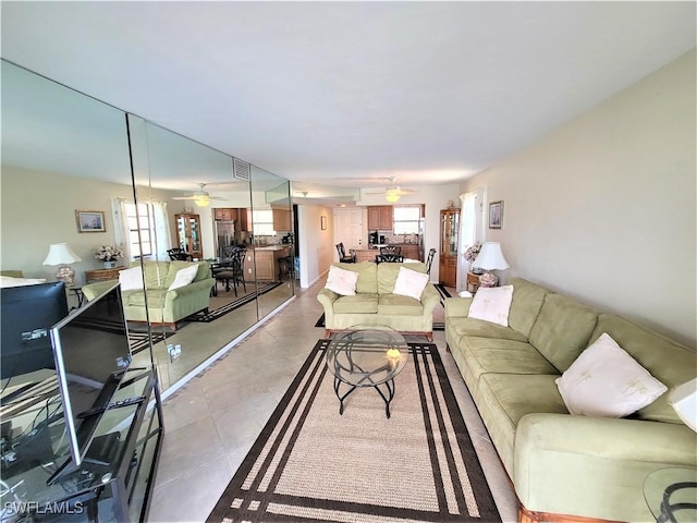 living room featuring ceiling fan and plenty of natural light