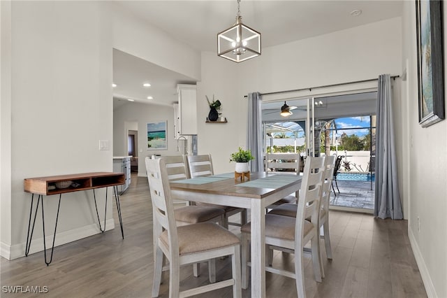 dining room with hardwood / wood-style flooring and an inviting chandelier