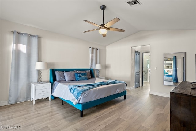 bedroom with ceiling fan, light hardwood / wood-style floors, and vaulted ceiling