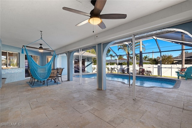 view of swimming pool with a lanai, a patio area, and ceiling fan