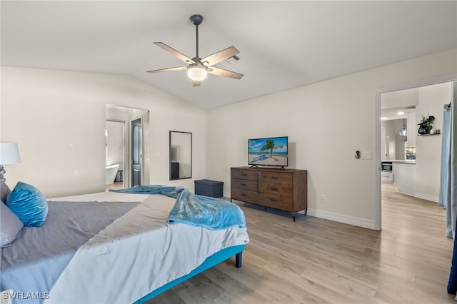 bedroom with ceiling fan, light hardwood / wood-style floors, vaulted ceiling, and ensuite bath