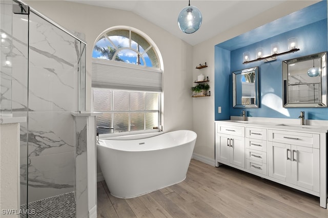 bathroom with hardwood / wood-style flooring, a wealth of natural light, lofted ceiling, and independent shower and bath