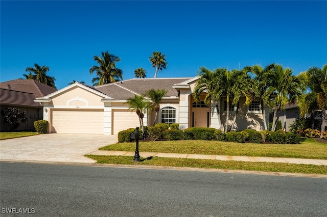 view of front facade featuring a front yard and a garage